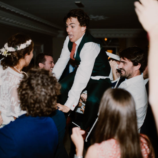 the groom is carried to his Jewish wedding at Mount Leuze